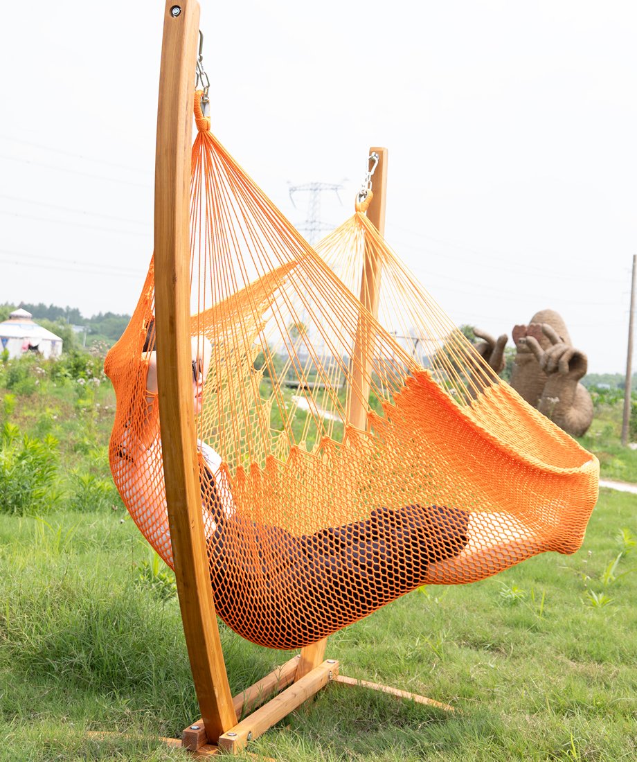 Display for fully extended effect of orange caribbean hammock chair and wooden stand combo